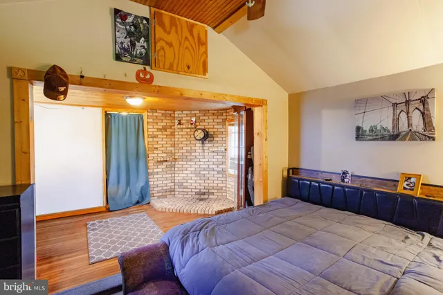 a bedroom with a bed and dresser with mirror