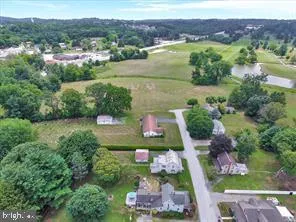 an aerial view of lake residential house with swimming pool and green space