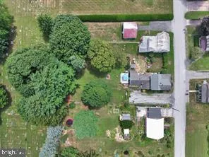 an aerial view of a house with a yard basket ball court and outdoor seating