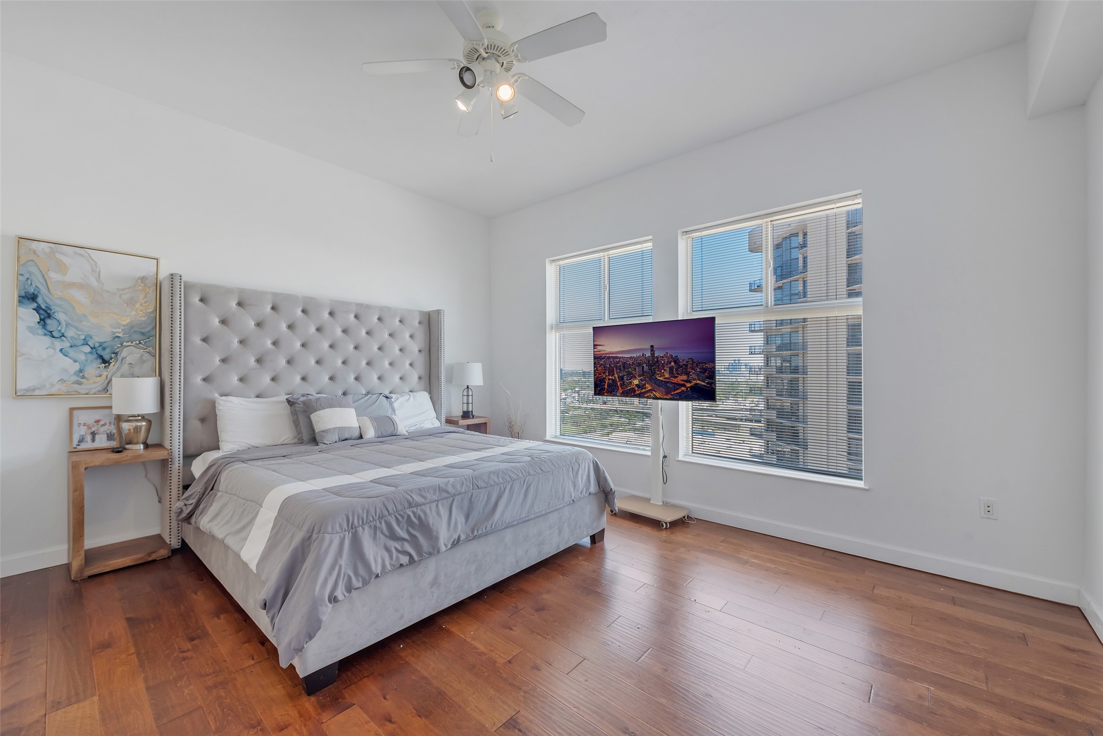3505 Sage Road, Unit 2210 Houston, TX 77056 - Photo 16 of 40 The main bedroom features hardwood floors, an oversized window that fills the space with natural light, a ceiling fan to keep you cool, and a generous layout offering both comfort and elegance.