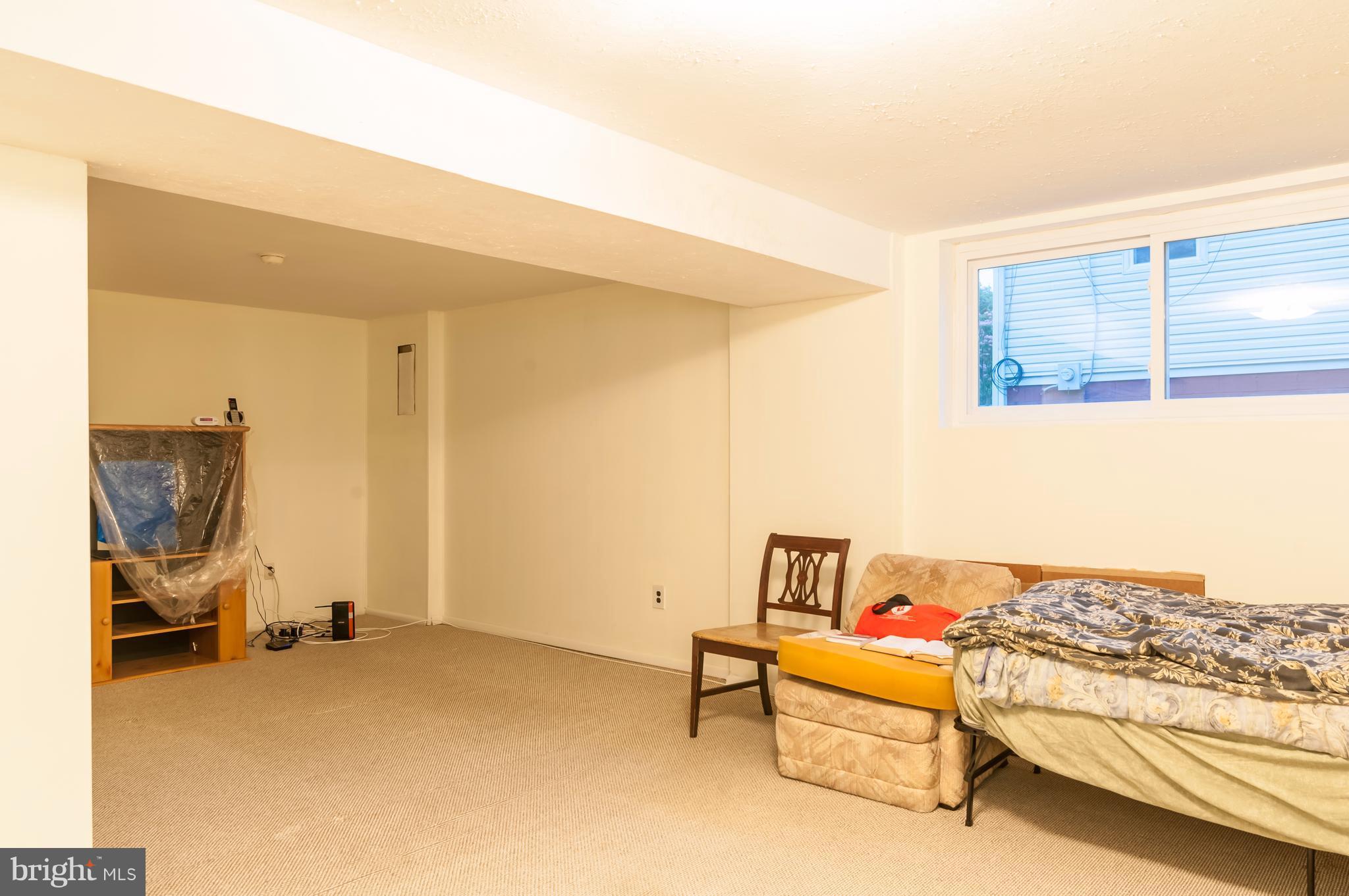 5702 Westgate Road Lanham, MD 20706 - Photo 14 of 22 a bedroom with furniture and a lamp
