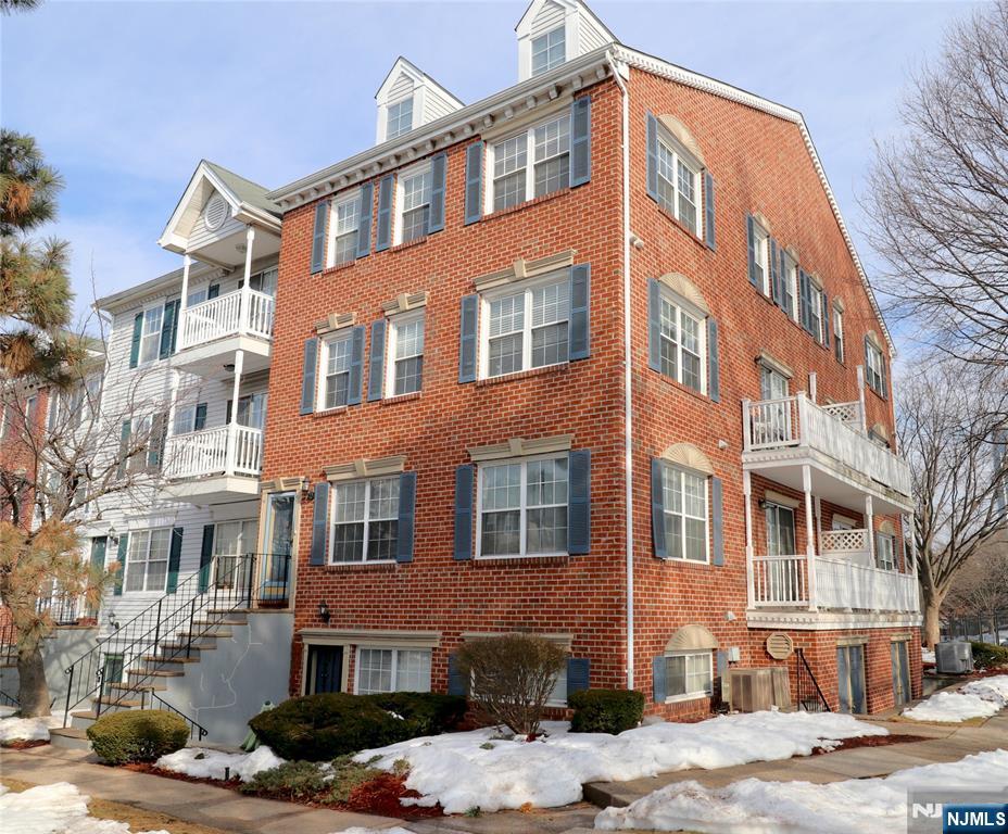 12 Rutgers Drive Newark, NJ 07103 - Photo 1 of 23 a front view of a building with lot of cars parked on the roadside