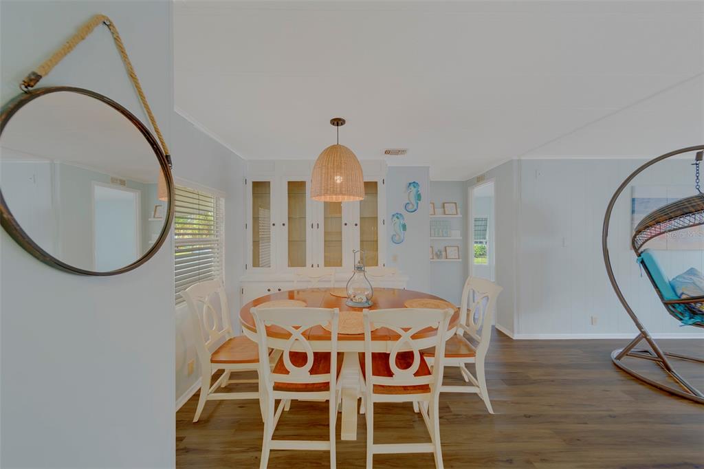 12501 Ulmerton Road, Unit 77 Largo, FL 33774 - Photo 12 of 73 a view of a dining room with furniture and wooden floor