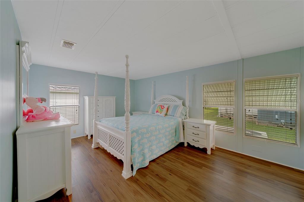 12501 Ulmerton Road, Unit 77 Largo, FL 33774 - Photo 15 of 73 a bedroom with a bed and wooden floor