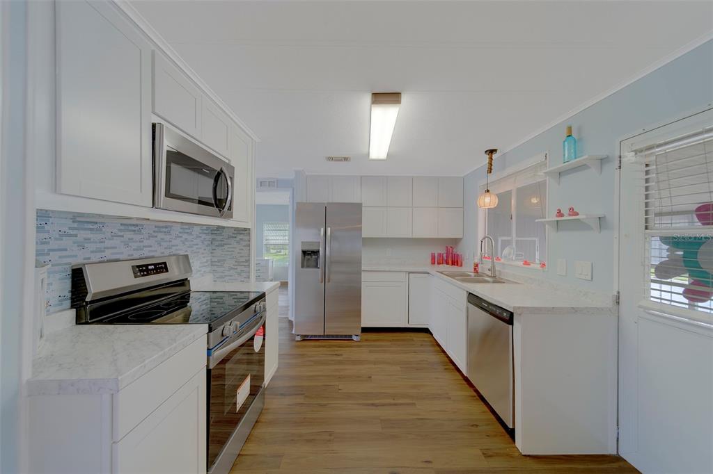12501 Ulmerton Road, Unit 77 Largo, FL 33774 - Photo 2 of 73 a kitchen with granite countertop cabinets stainless steel appliances and a counter space