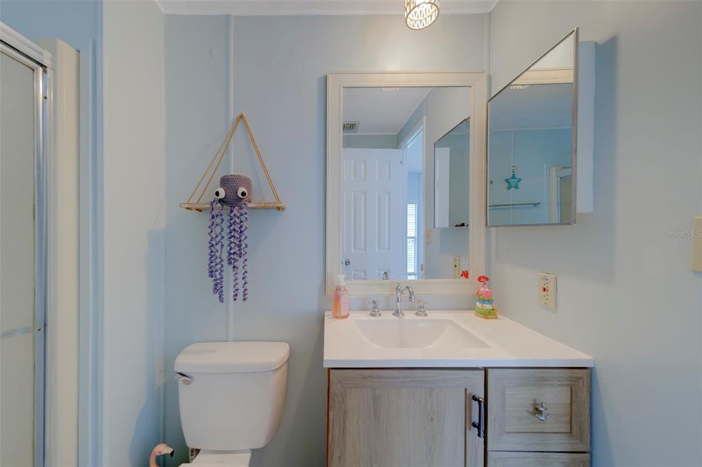 12501 Ulmerton Road, Unit 77 Largo, FL 33774 - Photo 21 of 73 a bathroom with a sink a toilet and mirror
