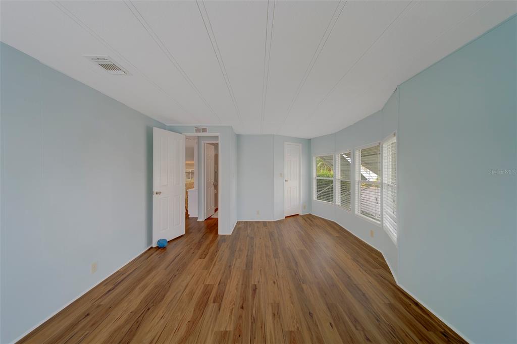 12501 Ulmerton Road, Unit 77 Largo, FL 33774 - Photo 25 of 73 wooden floor in an empty room with a window