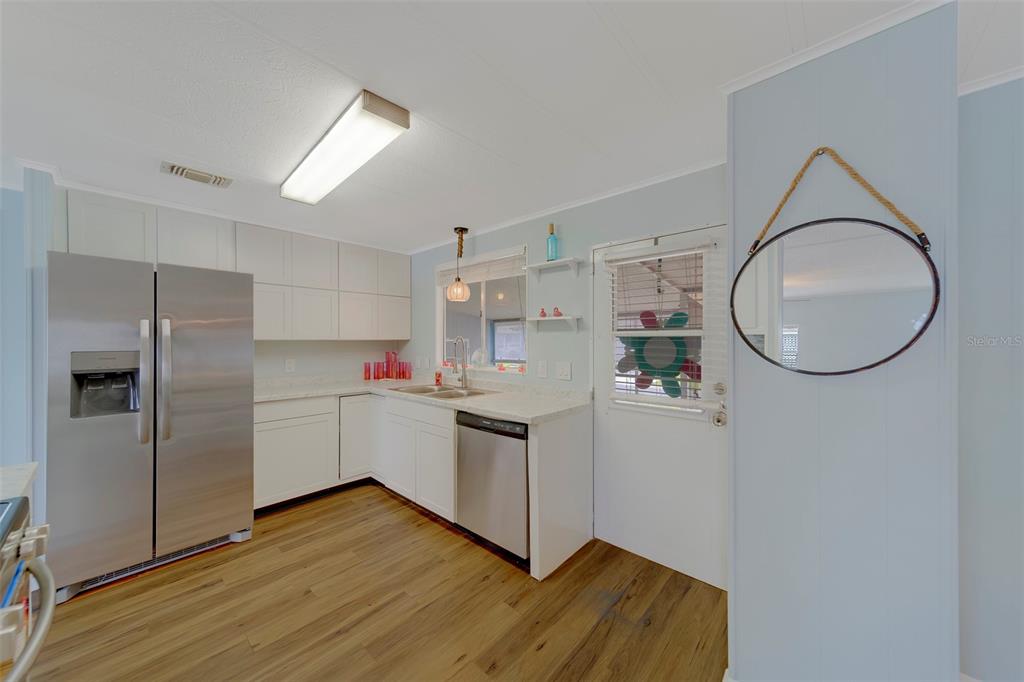12501 Ulmerton Road, Unit 77 Largo, FL 33774 - Photo 3 of 73 a kitchen with a refrigerator sink and cabinets