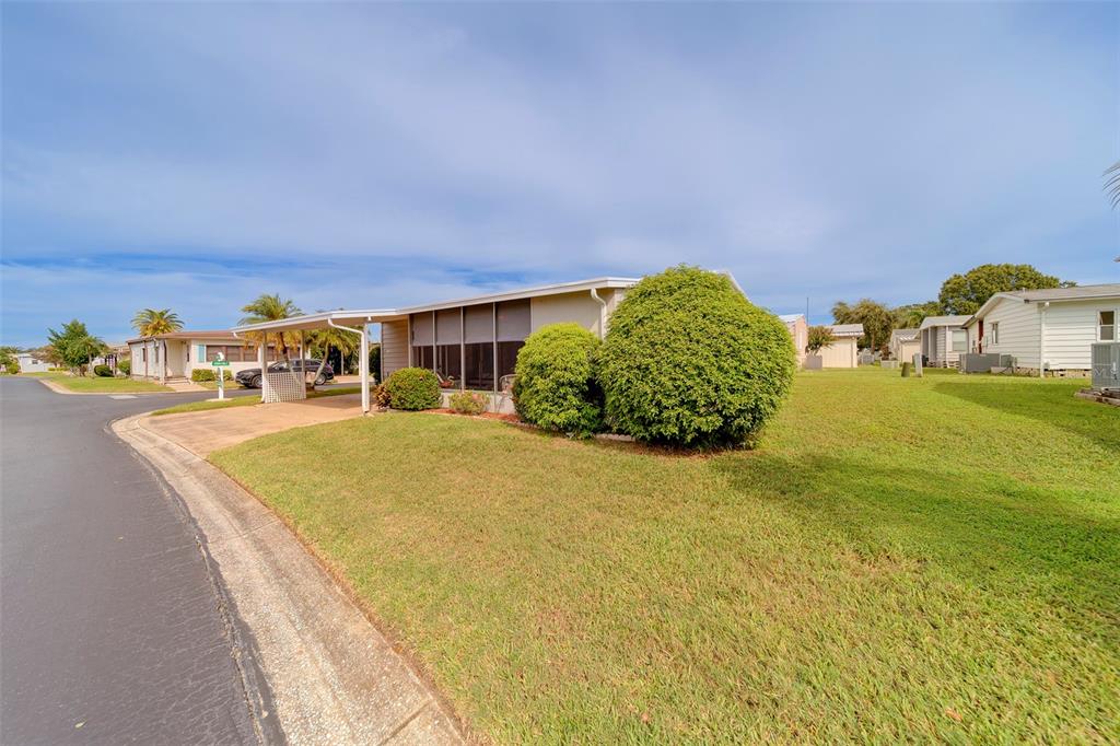 12501 Ulmerton Road, Unit 77 Largo, FL 33774 - Photo 37 of 73 a bed sitting in a bedroom next to a large window with outer view