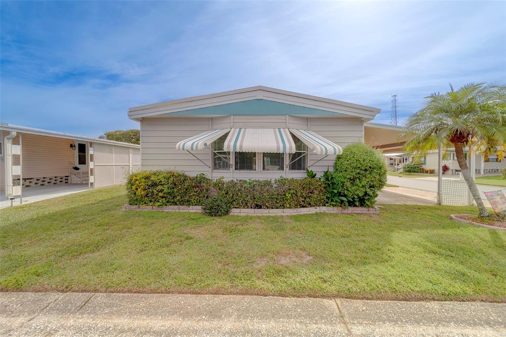 12501 Ulmerton Road, Unit 77 Largo, FL 33774 - Photo 41 of 73 a front view of a house with garden