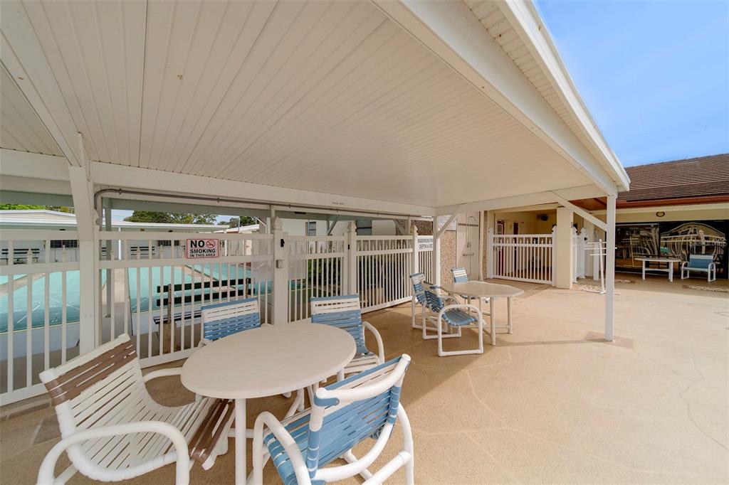 12501 Ulmerton Road, Unit 77 Largo, FL 33774 - Photo 48 of 73 a dining room with furniture and a floor to ceiling window