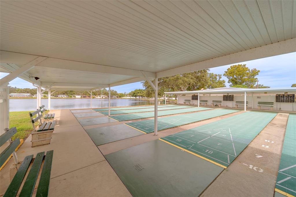 12501 Ulmerton Road, Unit 77 Largo, FL 33774 - Photo 50 of 73 a view of a patio with table and chairs with wooden floor