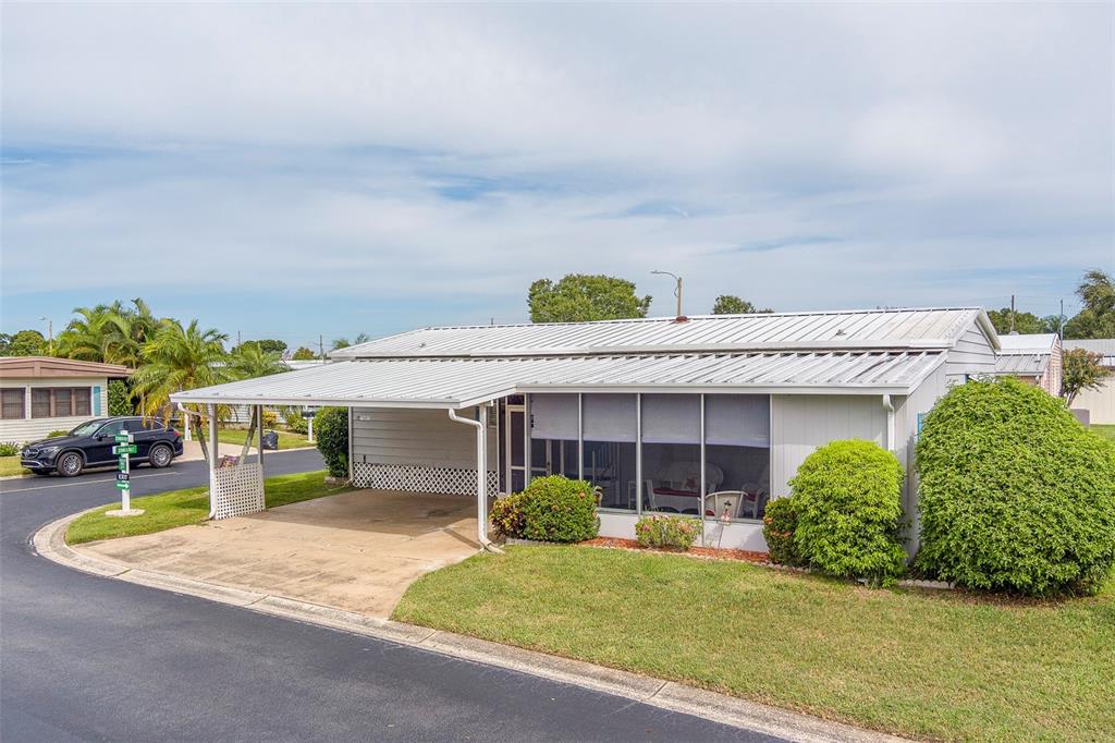 12501 Ulmerton Road, Unit 77 Largo, FL 33774 - Photo 55 of 73 a view of a house with a yard and potted plants