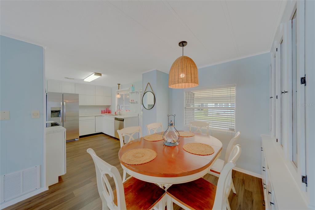 12501 Ulmerton Road, Unit 77 Largo, FL 33774 - Photo 7 of 73 a view of a dining room with furniture and wooden floor