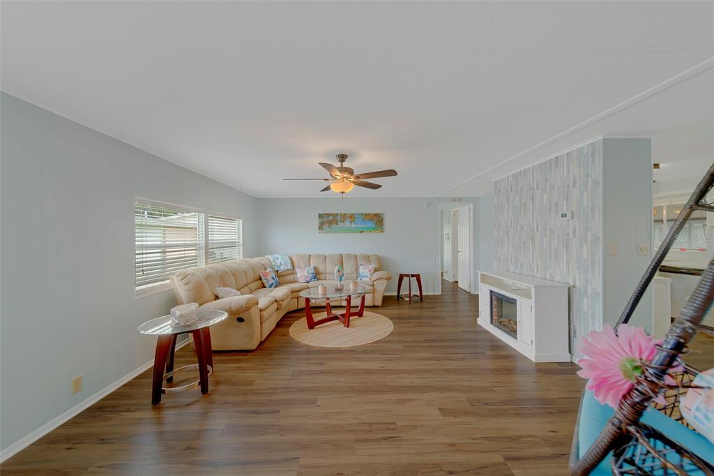 12501 Ulmerton Road, Unit 77 Largo, FL 33774 - Photo 9 of 73 a living room with furniture a dining table and a fireplace