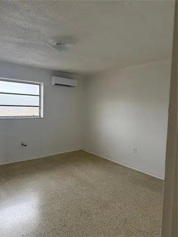 an empty room with a empty space and window