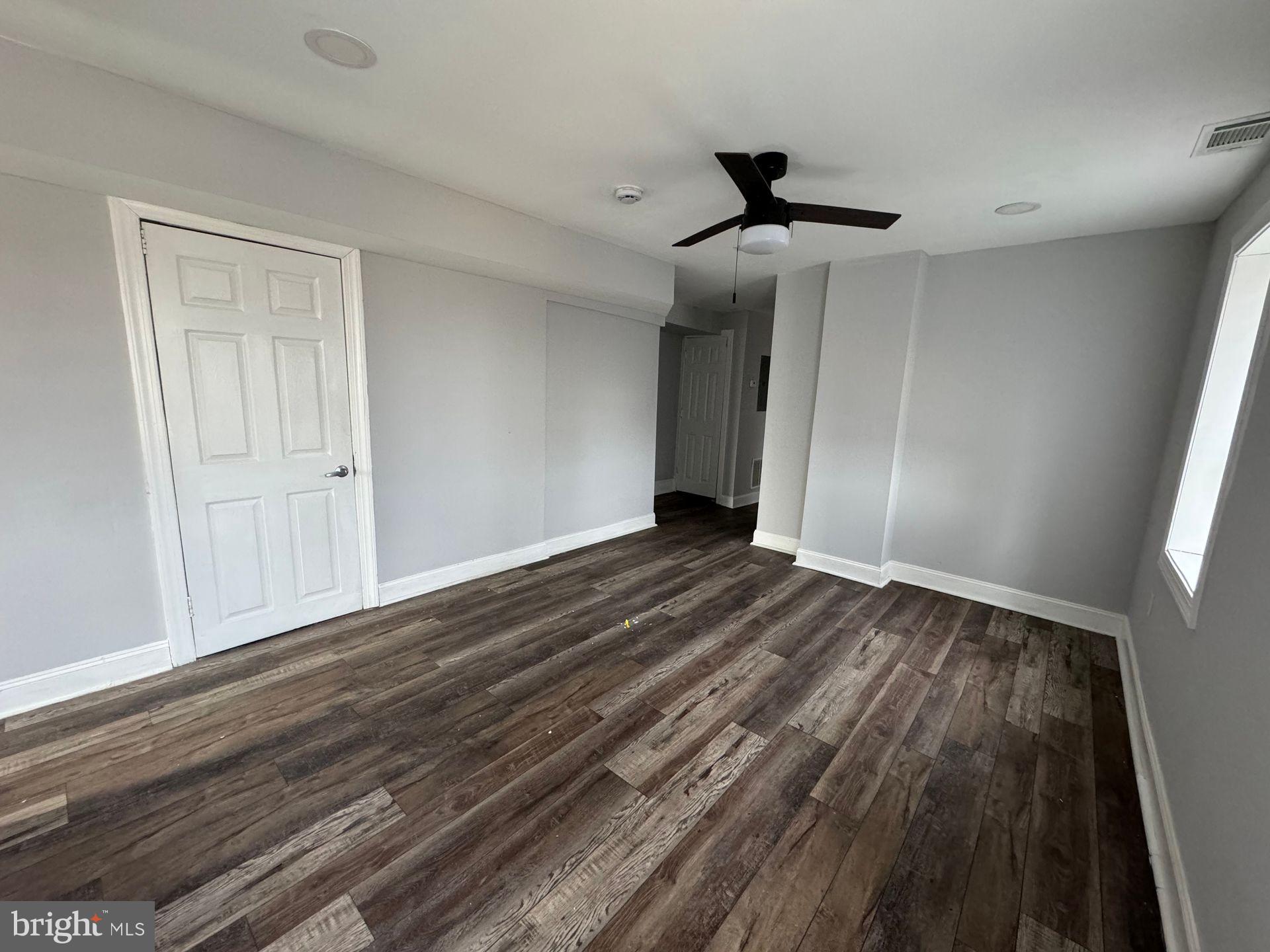 610 9th Street, Unit 2 Chester, PA 19013 - Photo 6 of 8 a view of a livingroom with wooden floor and a ceiling fan