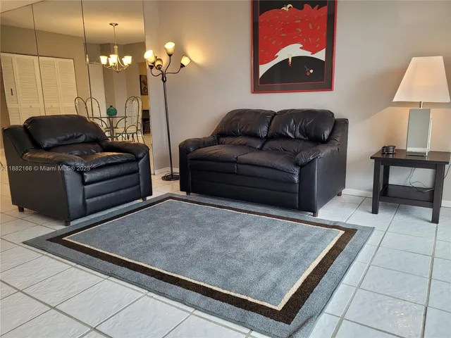 a very nice looking living room with furniture and floor to ceiling windows
