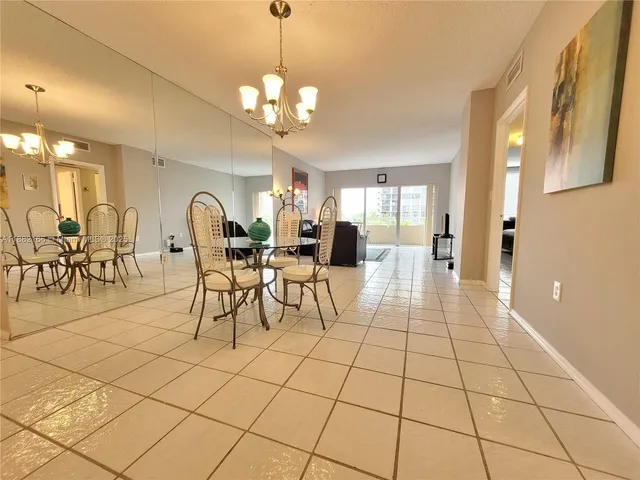 a bathroom with a granite countertop sink a toilet a mirror and shower