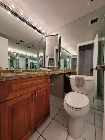 a view of a lake from a chairs and table in the patio