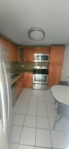 a living room with furniture and a lamp