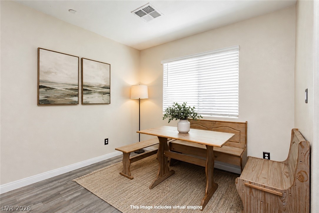 12369 Golden Wreath Road, Unit 2 Las Vegas, NV 89183 - Photo 7 of 19 A well-lit breakfast nook with rich hardwood flooring.