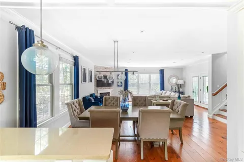 a living room with furniture fireplace and wooden floor