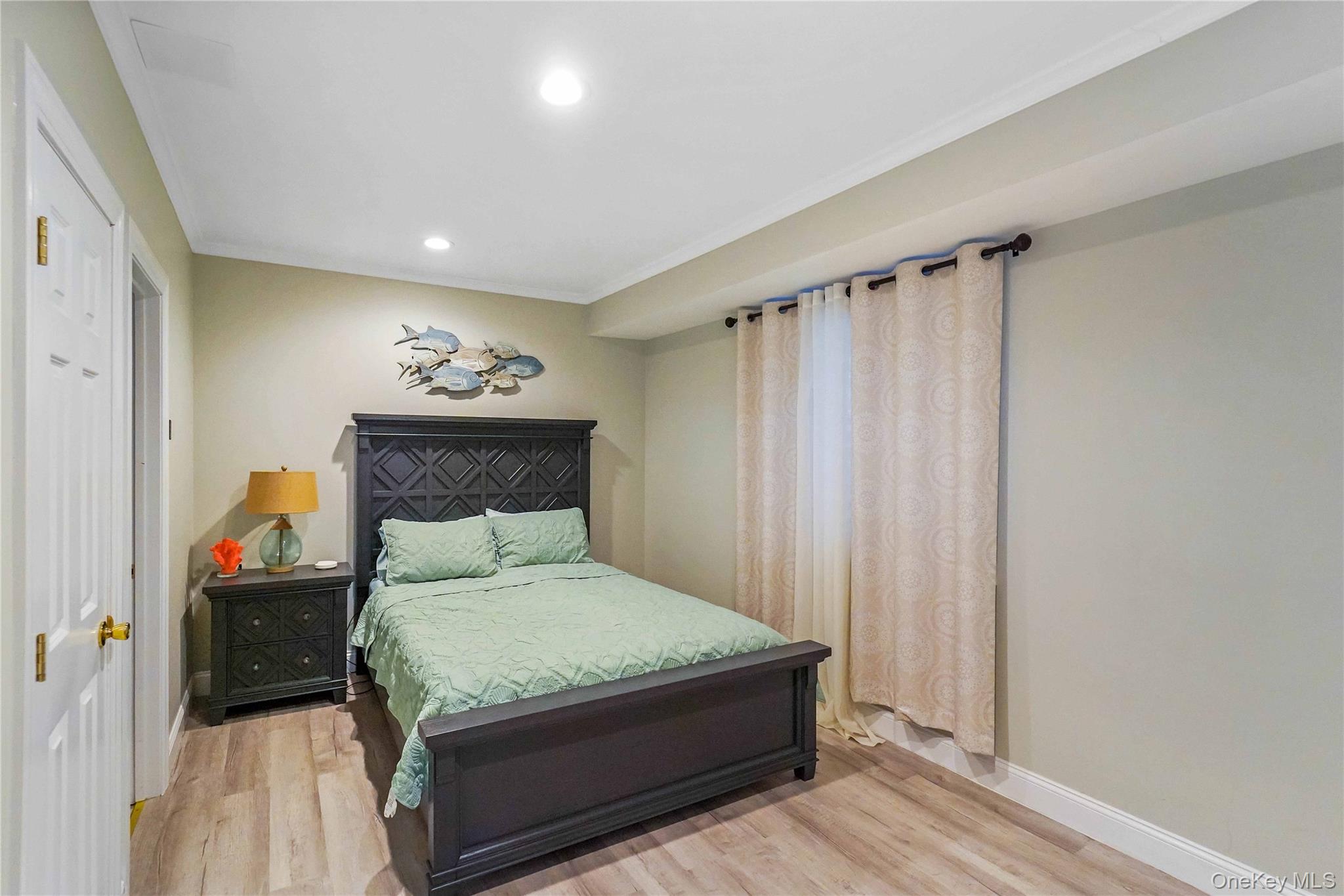 39 Foster Road, Unit A Quogue, NY 11959 - Photo 20 of 21 a bedroom with a bed and a mirror