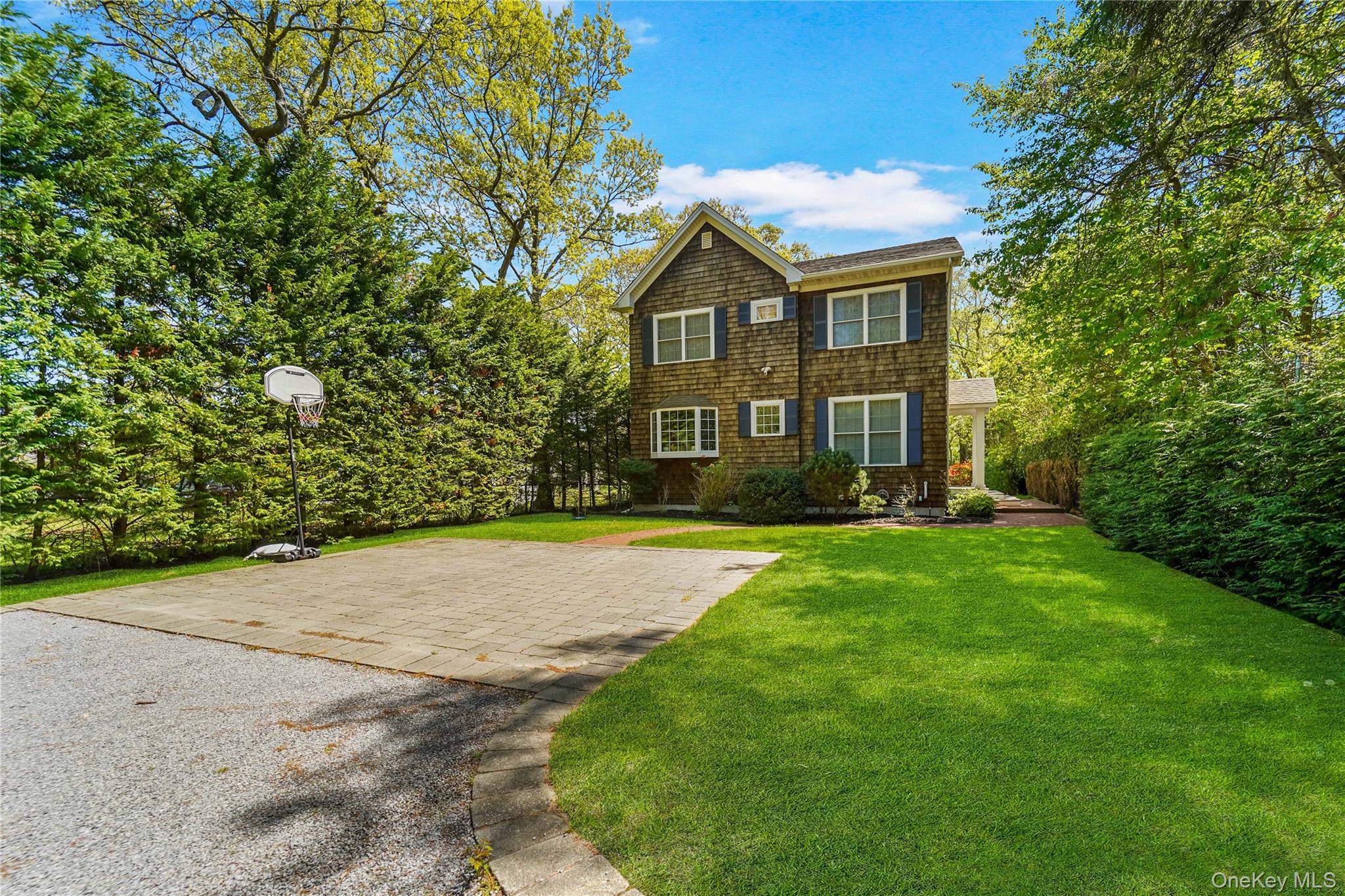 39 Foster Road, Unit A Quogue, NY 11959 - Photo 2 of 21 a front view of a house with a yard