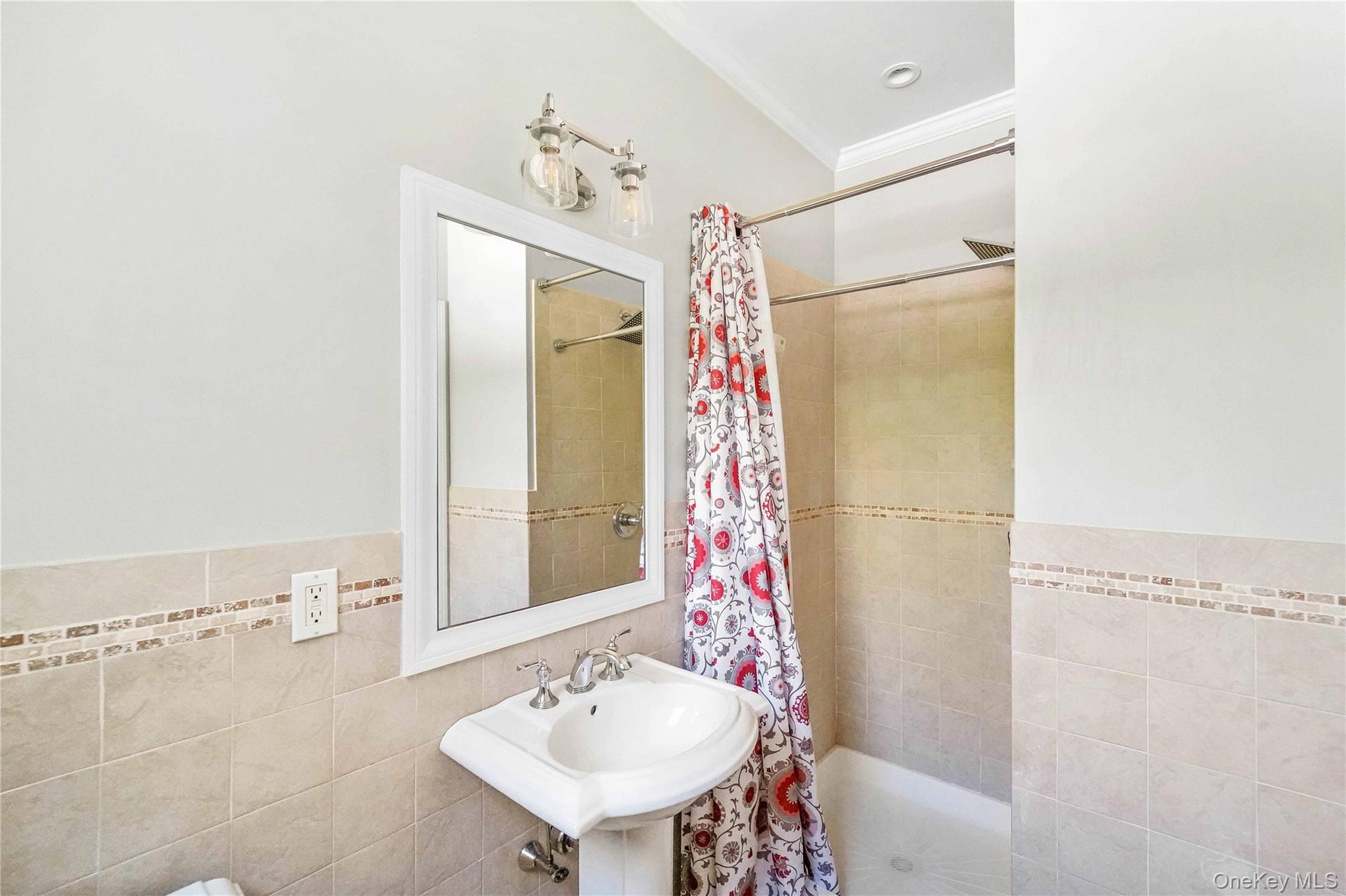 39 Foster Road, Unit A Quogue, NY 11959 - Photo 5 of 21 a bathroom with a sink mirror and a shower