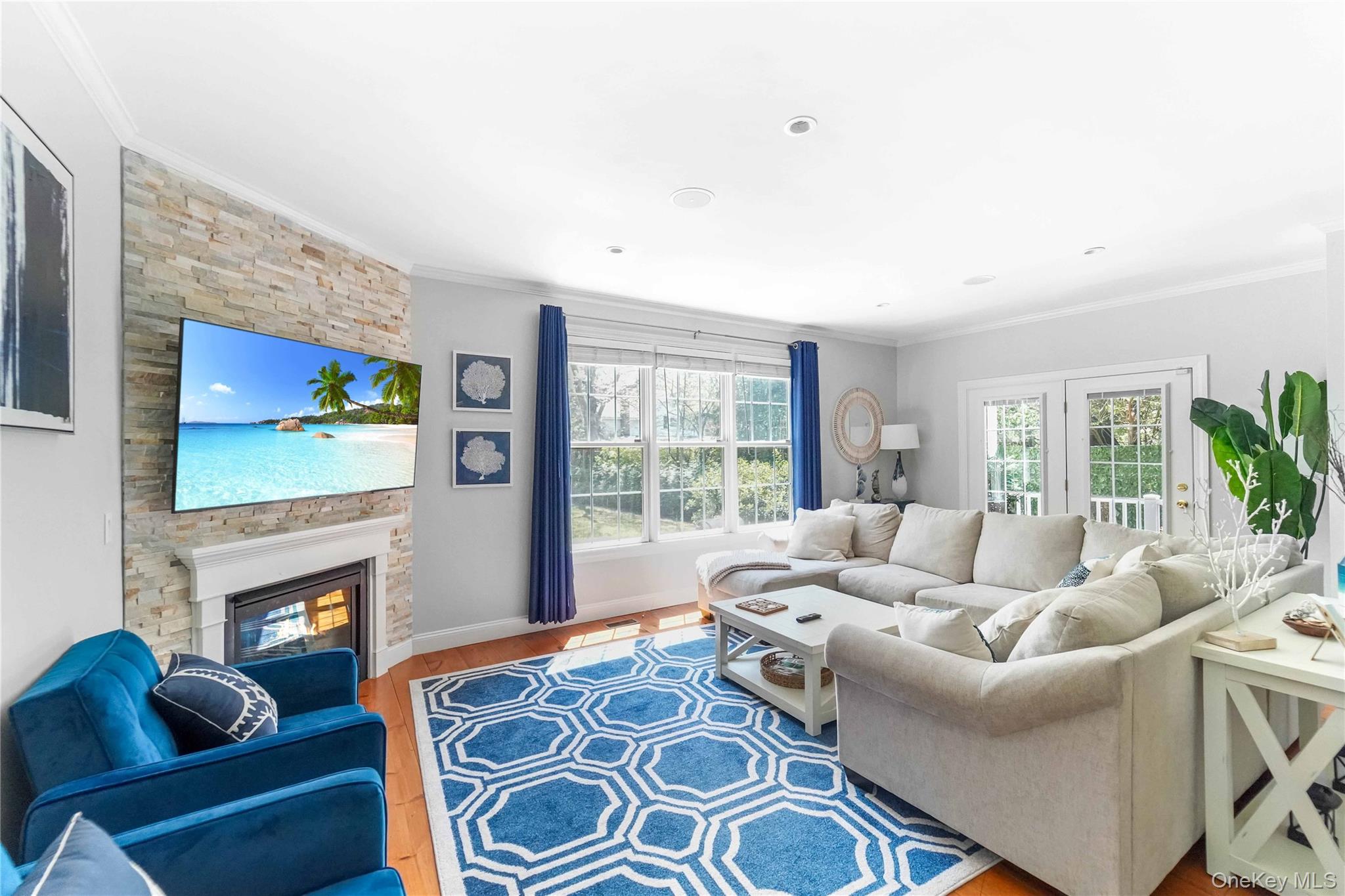 39 Foster Road, Unit A Quogue, NY 11959 - Photo 8 of 21 a living room with furniture a large window and a fireplace