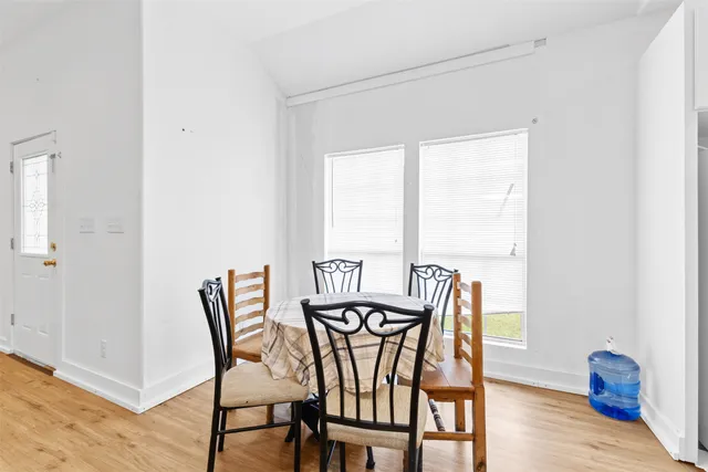 a view of a dining room with furniture and wooden floor