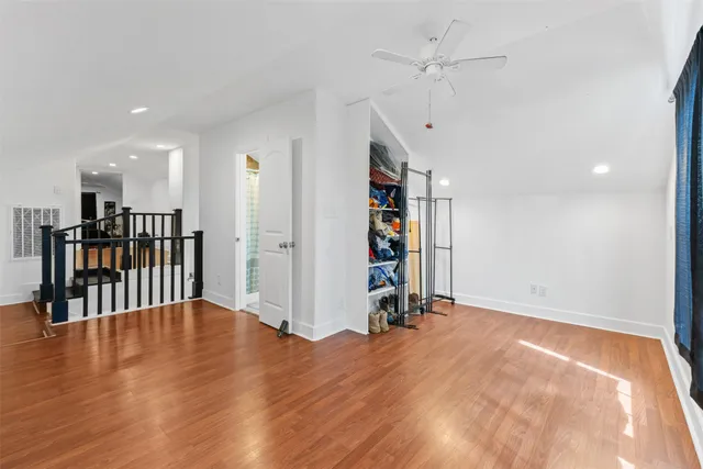 a view of an empty room with a window and a ceiling fan