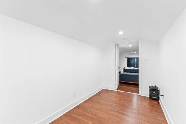 a view of a room with wooden floor and a sink