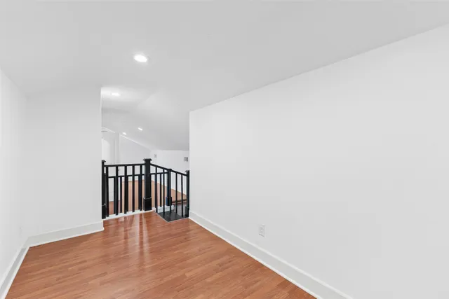 a view of hallway with wooden floor