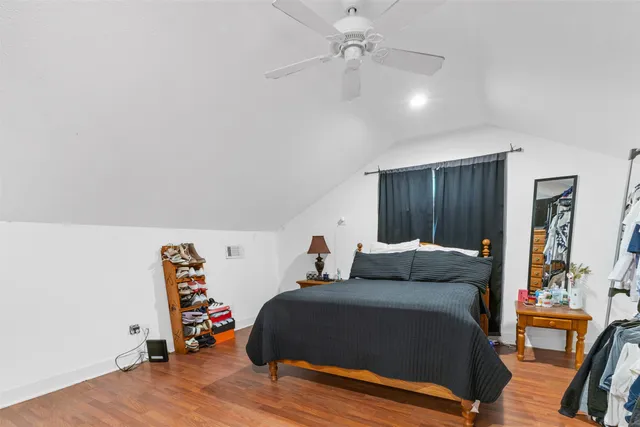 a bedroom with a bed and wooden floor