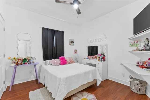 a bedroom with a bed and flat screen tv