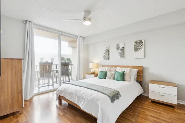 a bedroom with a bed and large window