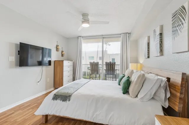 a bedroom with a bed and a flat screen tv