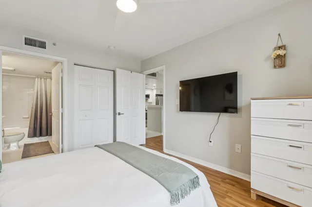 a bathroom with a sink a toilet a mirror and a shower