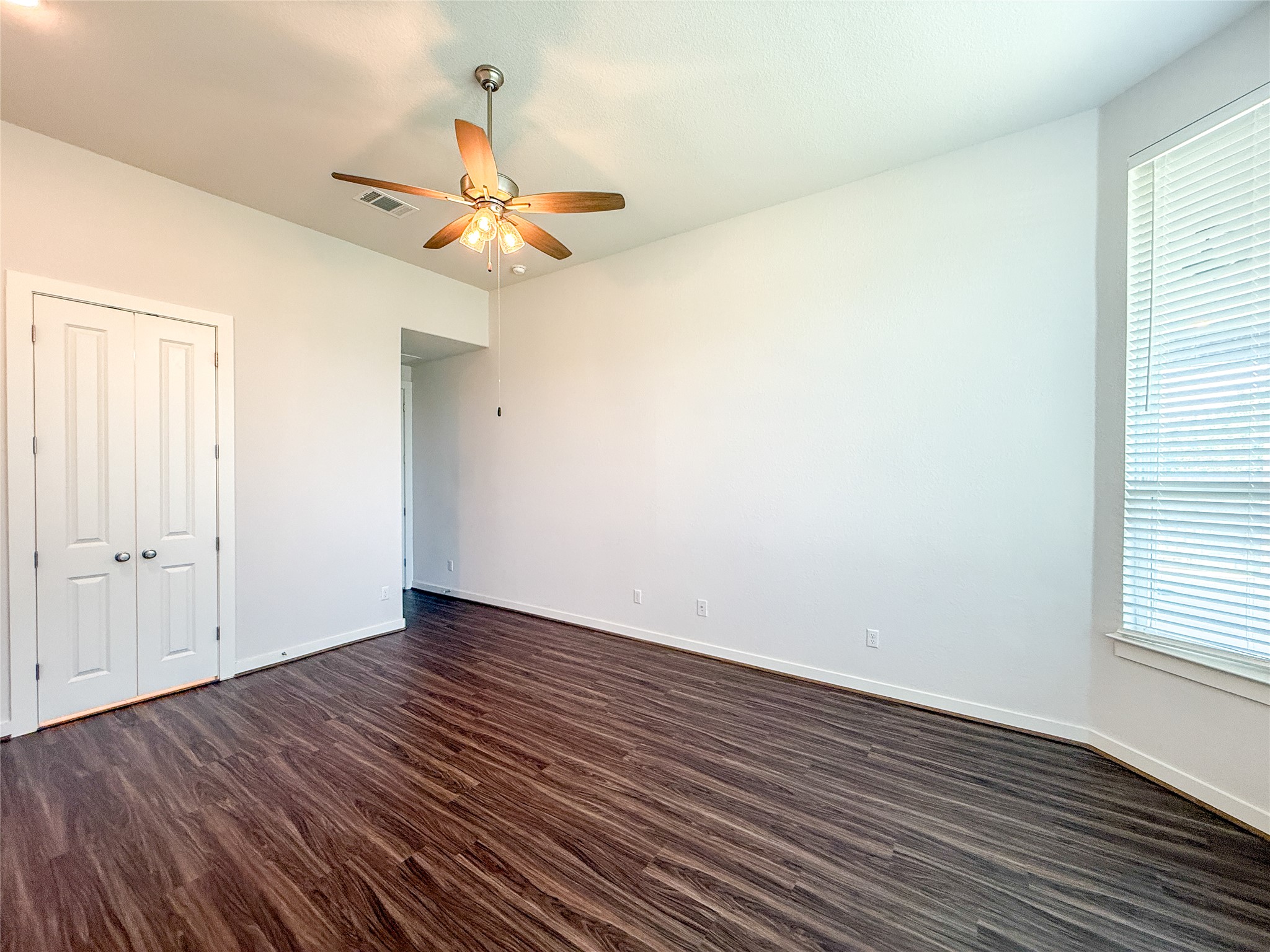 249 Heartleaf Road San Marcos, TX 78666 - Photo 20 of 38 A quiet bedroom featuring rich hardwood flooring, a ceiling fan, and ample natural light.