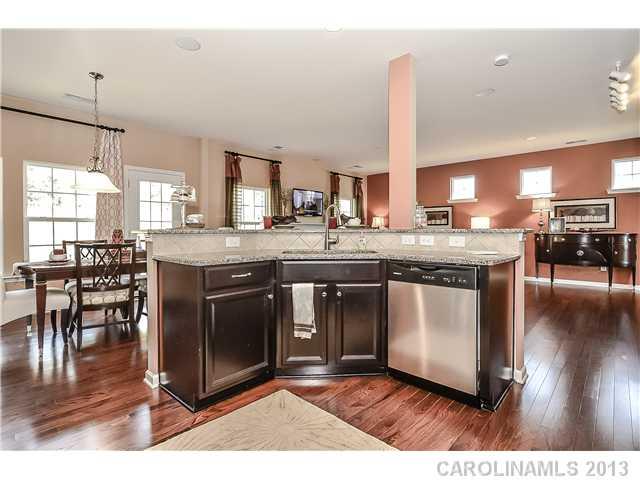 78166 Rillstone Drive, Unit 219 Lancaster, SC 29720 - Photo 6 of 16 a kitchen with stainless steel appliances granite countertop a stove a sink and a wooden floors
