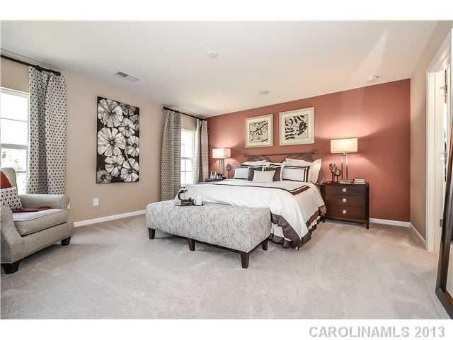 78166 Rillstone Drive, Unit 219 Lancaster, SC 29720 - Photo 9 of 16 a bedroom with a large bed couch and a window