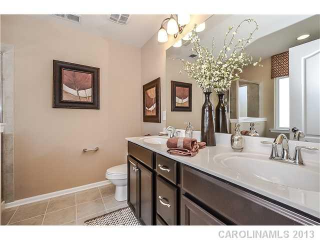 78166 Rillstone Drive, Unit 219 Lancaster, SC 29720 - Photo 10 of 16 a bathroom with a sink a toilet and a mirror