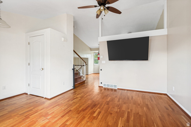 843 Deer Flat Road Tooele, UT 84074 - Photo 5 of 27 Open-concept interior featuring wood-finish flooring, a ceiling fan, and a mounted display