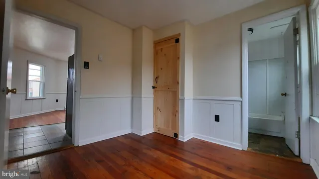 a view of hallway with wooden floor