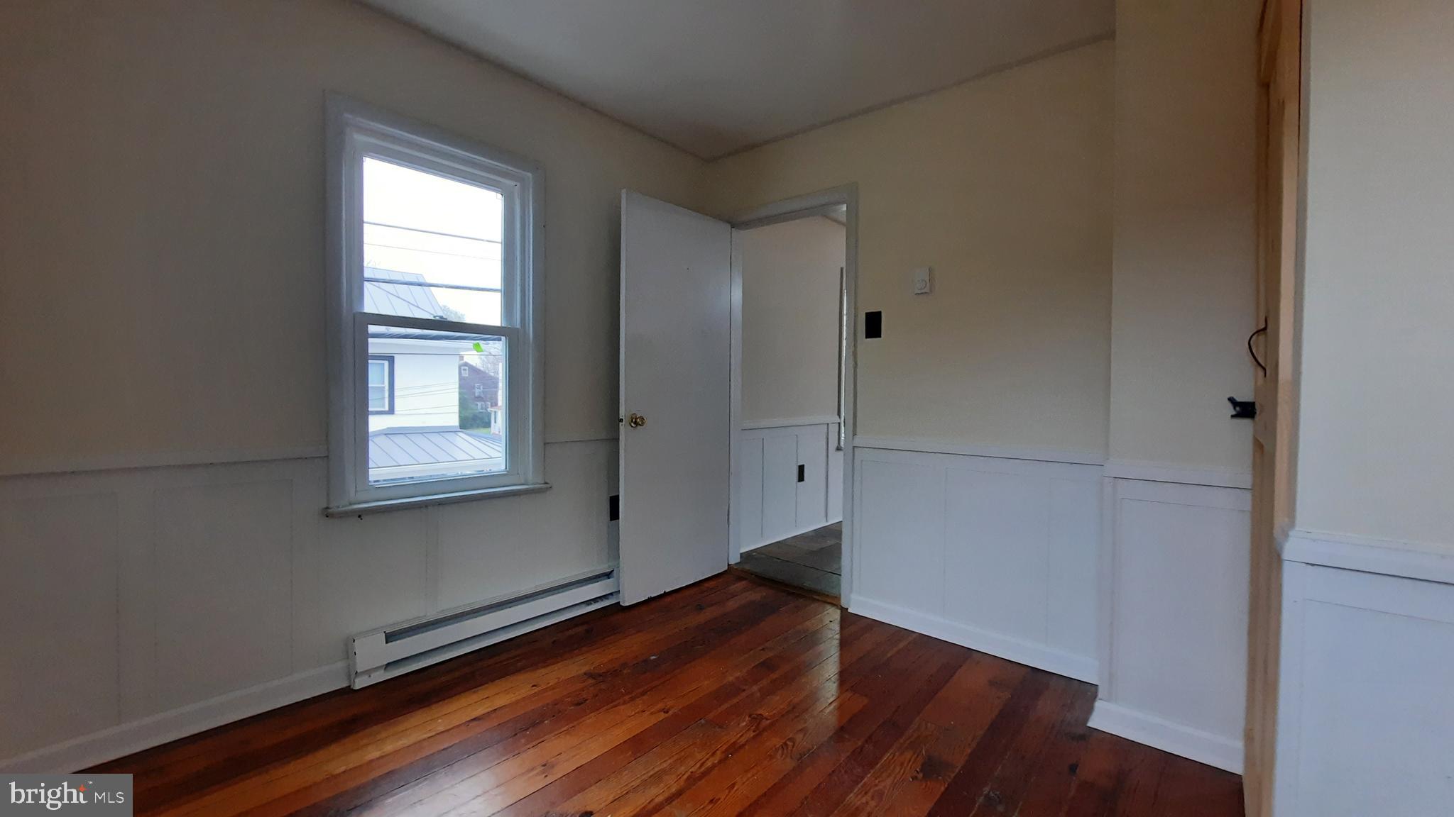 203 Cloud Street, Unit 4 Front Royal, VA 22630 - Photo 4 of 9 an empty room with wooden floor and windows