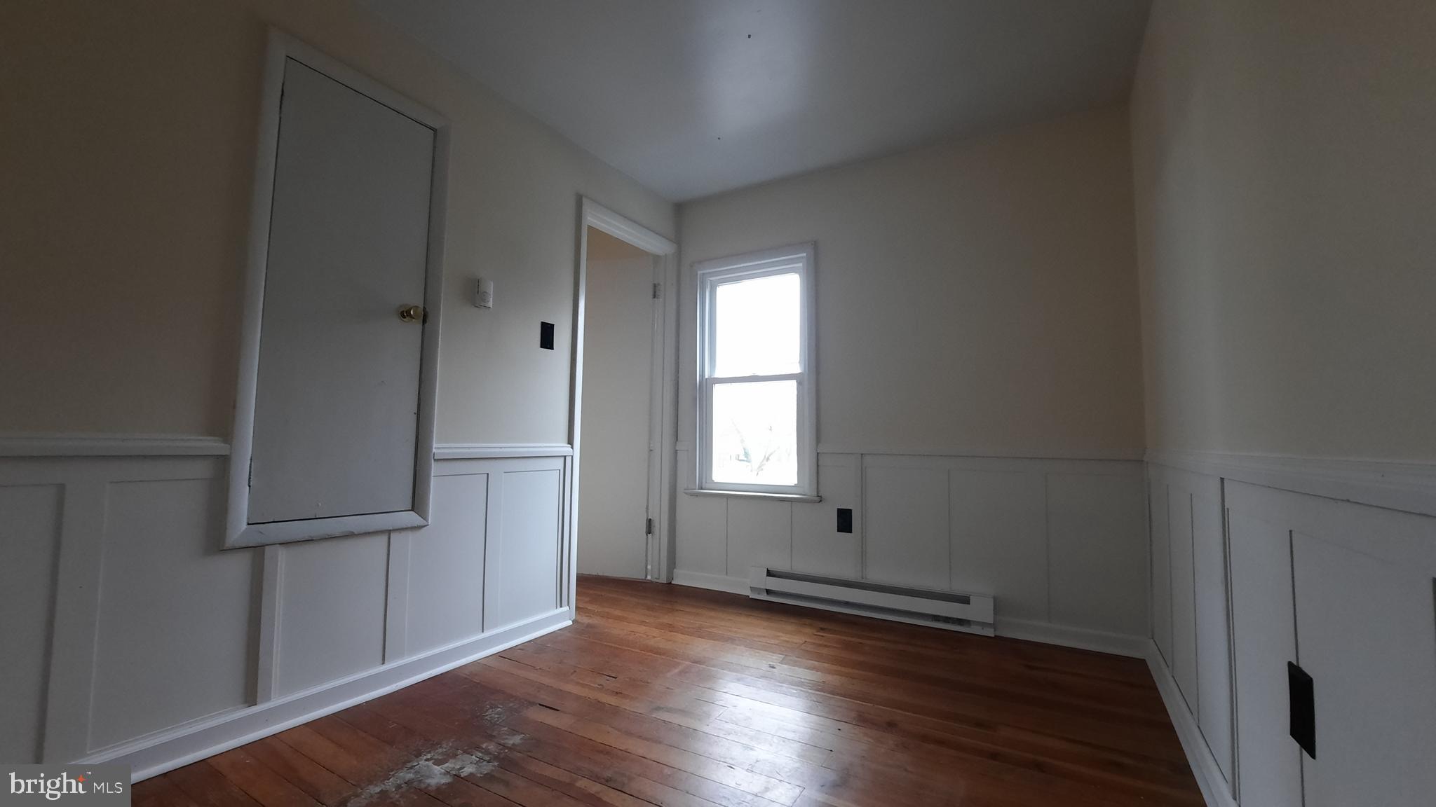 203 Cloud Street, Unit 4 Front Royal, VA 22630 - Photo 7 of 9 an empty room with wooden floor and a window