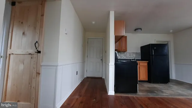 a kitchen with granite countertop a refrigerator and a stove
