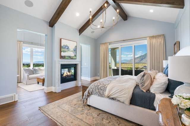 115 East Hidden Ridge Lane, Unit 42 Mapleton, UT 84664 - Photo 4 of 103 Vaulted ceilings with exposed wood beams, a built-in fireplace with a white mantel, and wood-finish flooring